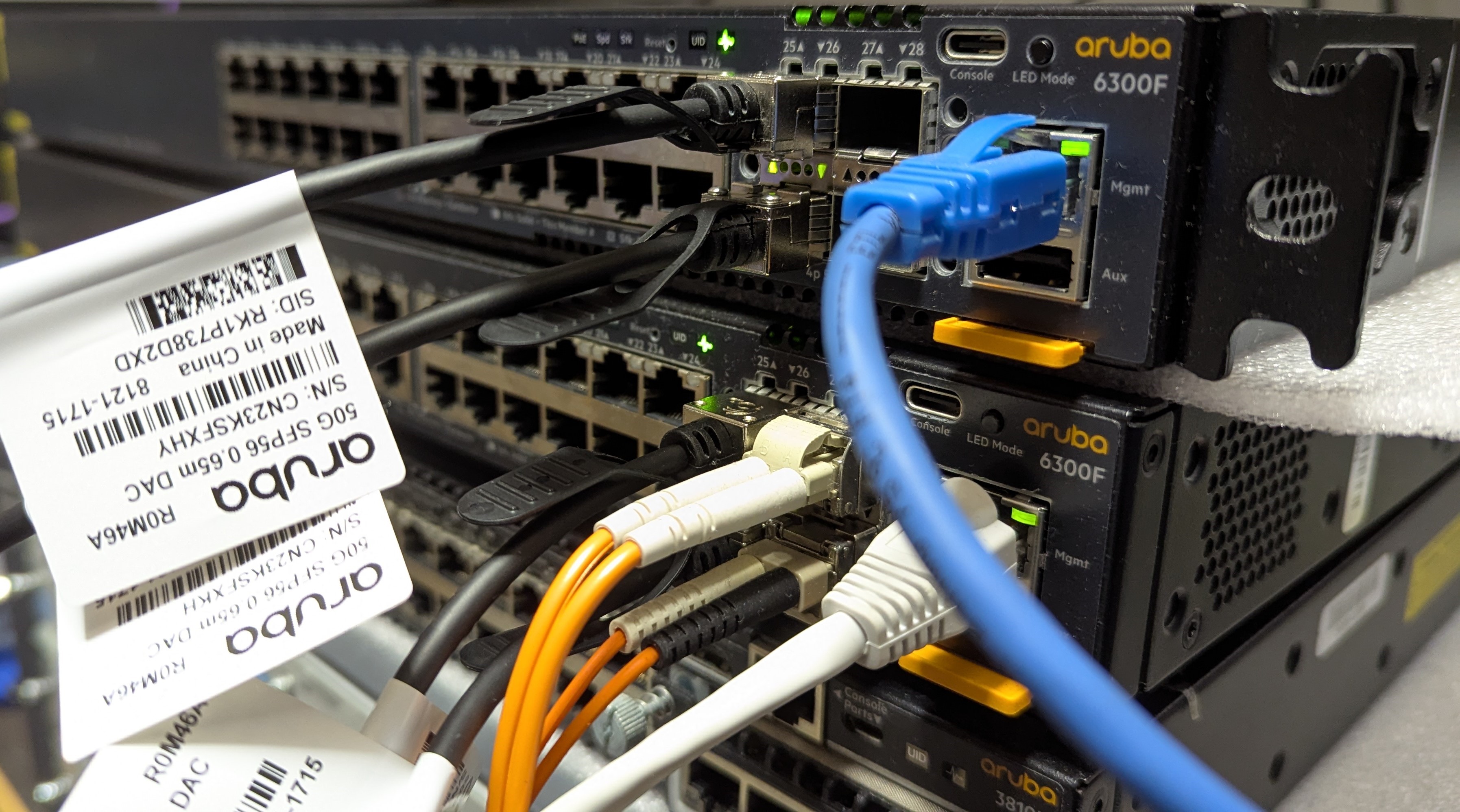A pair of CX 6300F switches stacked on top of exach other and connected with 50Gb DAC cables